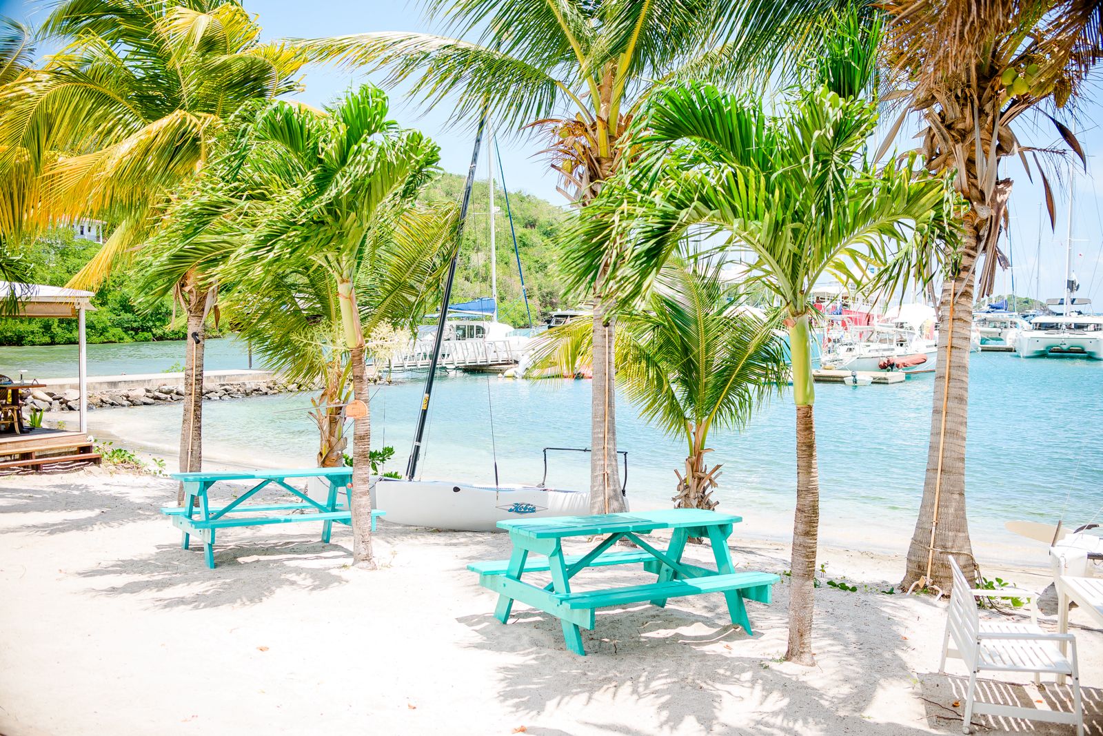 Beach dining area with turquoise tables at best places for investment properties